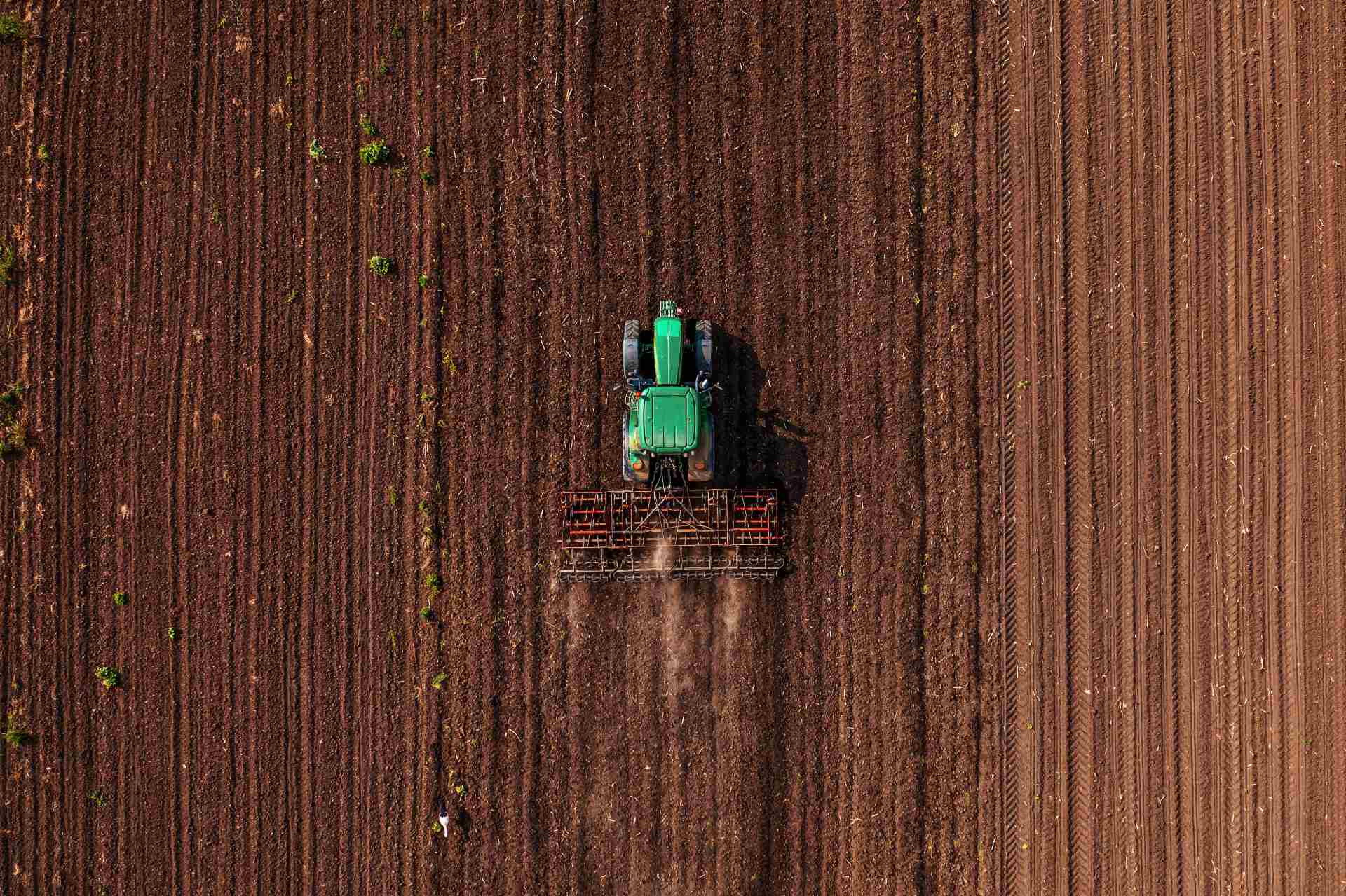 green tractor and tiller ready for sale