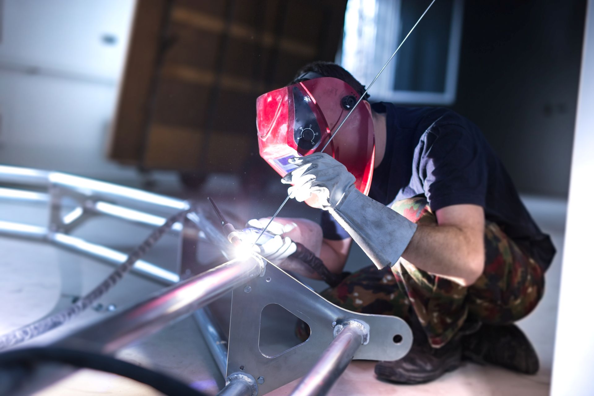 a welder working with a stick weld